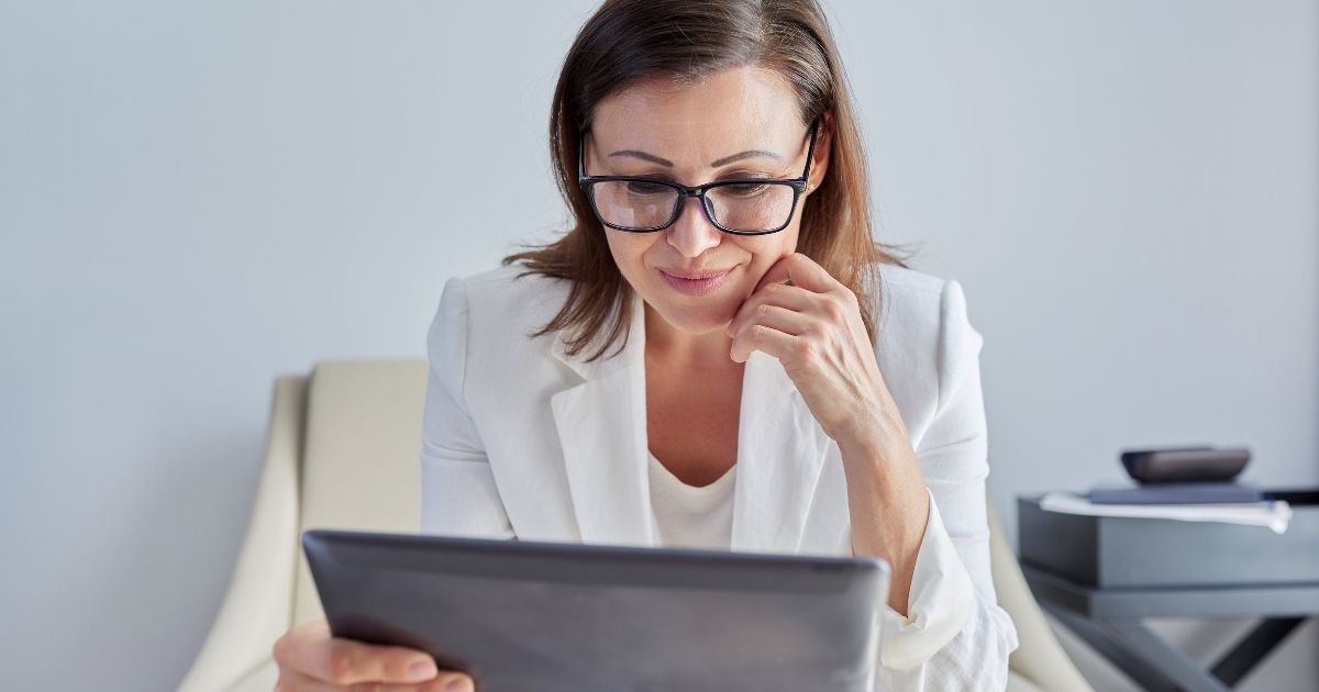 Woman Looking At Tablet During Virtual Therapy Session | I Don't Want To Go To Therapy Today