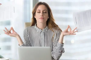 Woman Meditating At Work | How To Manage Stress At Work | Breaking Dawn Therapy