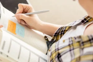 Woman Writing In Planner | Succeed In The New Year | Breaking Dawn Therapy