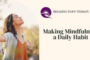 A Woman With Her Arms Spread Open With Her Eyes Closed Feeling at Peace | Making Mindfulness a Daily Habit | Breaking Dawn Therapy
