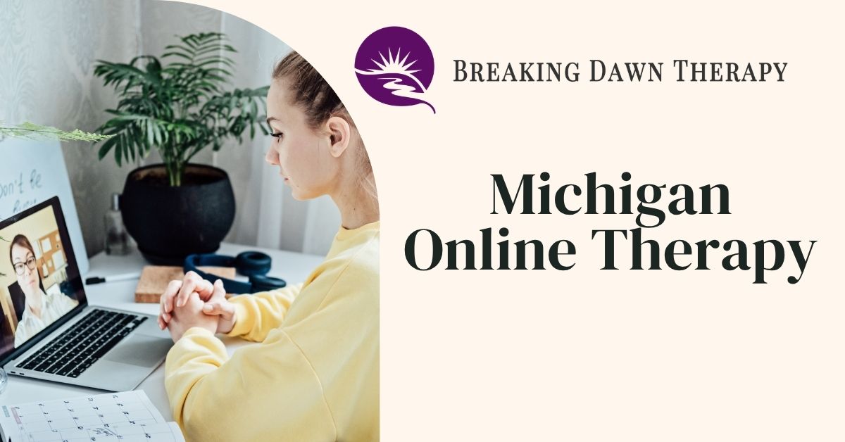 Promotional graphic for Breaking Dawn Therapy advertising Michigan online therapy, featuring a woman at a desk in a video therapy session on a laptop, with the brand logo and the words “Michigan Online Therapy” on a cream background.